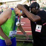 
              Wilbert Greaves gives Kristjan Ceh, of Slovenia, his gold medal after the final of the men's discus throw at the World Athletics Championships on Tuesday, July 19, 2022, in Eugene, Ore. (AP Photo/David J. Phillip)
            