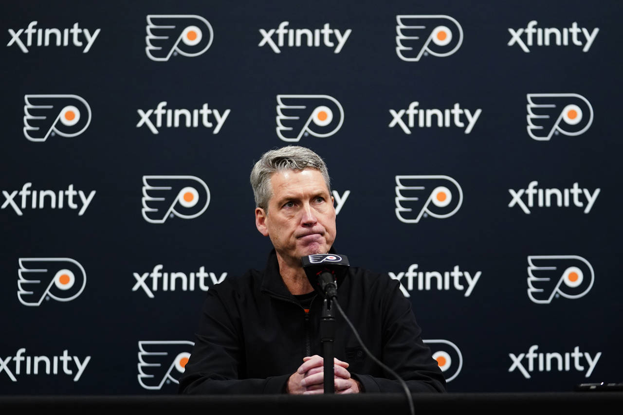 FILE - Philadelphia Flyers General Manager Chuck Fletcher pauses while speaking during a news confe...