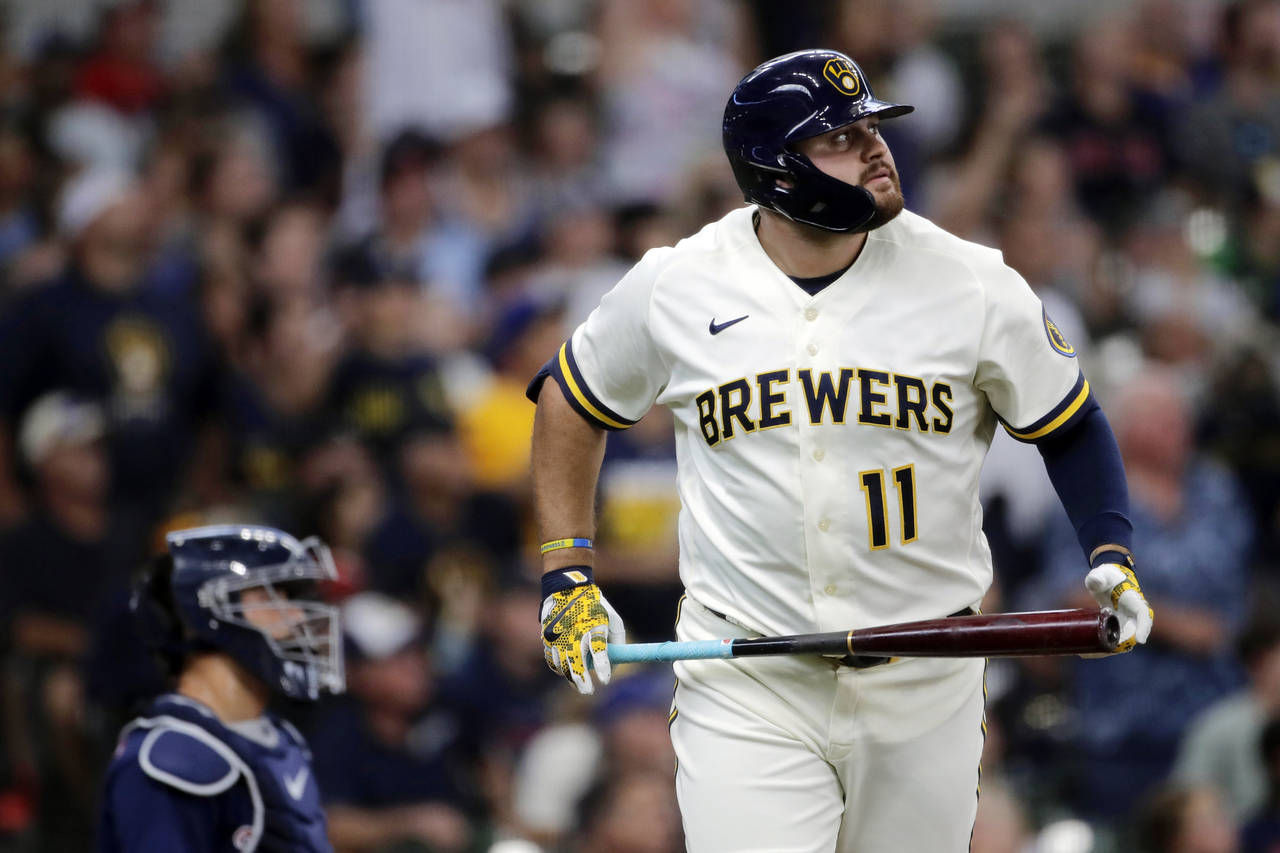 Milwaukee Brewers' Rowdy Tellez watches his three-run home run during the first inning of a basebal...