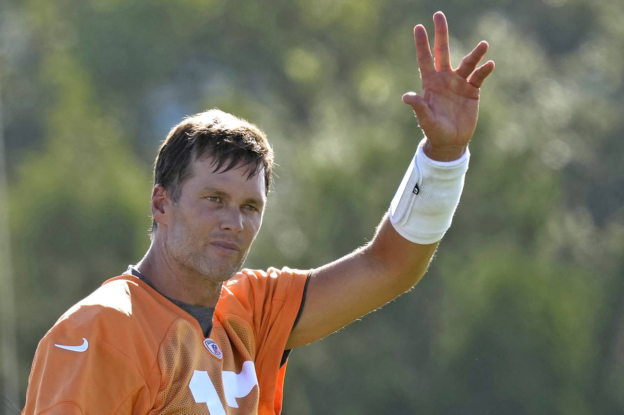 Tampa Bay Buccaneers quarterback Tom Brady waves to the fans during an NFL football training camp p...