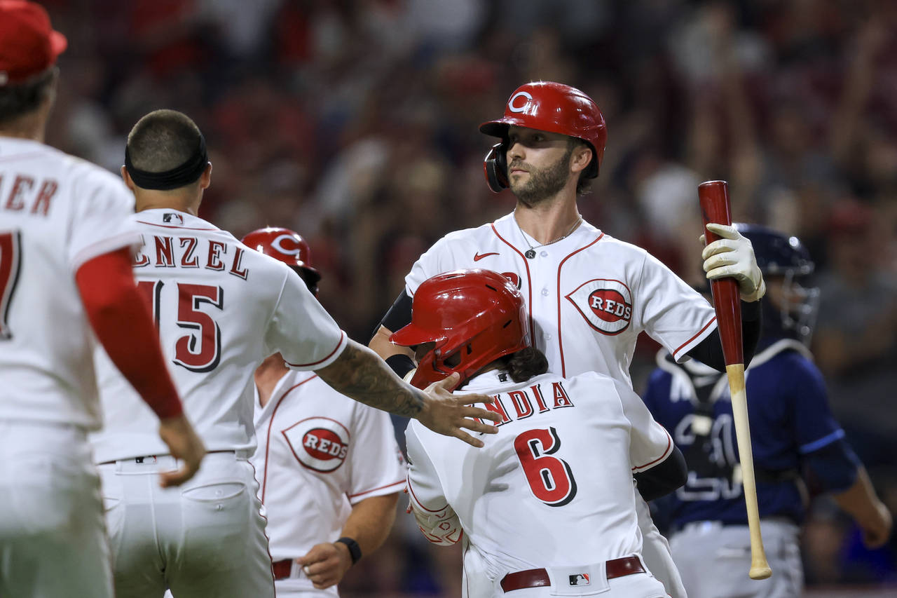 Cincinnati Reds' Tyler Naquin celebrates with teammates, including Jonathan India, after a balk by ...