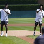 
              Detroit Pistons' Jalen Duren, left, and Jaden Ivey throw ceremonial pitches before a baseball game between the Detroit Tigers and Kansas City Royals in Detroit, Saturday, July 2, 2022. (AP Photo/Paul Sancya)
            