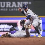 
              Colorado Rockies' Brendan Rodgers slides to second base against Milwaukee Brewers shortstop Willy Adames for a double during the ninth inning of a baseball game Saturday, July 23, 2022, in Milwaukee. (AP Photo/Kenny Yoo)
            