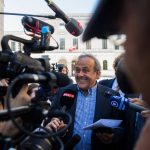 
              The former president of the the European Football Association (Uefa), Michel Platini, center, surrounded by media representatives, speaks to the press in front of the Swiss Federal Criminal Court in Bellinzona, Switzerland, at the last day of the trail, after the verdict has been announced, Friday, July 8, 2022. The trial ended with an acquittal. Former Fifa President Joseph Blatter and Platini, stood trial before the Federal Criminal Court over a suspicious two-million payment. The Federal Prosecutor's Office accused them of fraud. The defense spoke of a conspiracy. (Ti-Press/Alessandro Crinari/Keystone via AP)
            