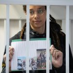 
              WNBA star and two-time Olympic gold medalist Brittney Griner holds images standing in a cage at a court room prior to a hearing, in Khimki just outside Moscow, Russia, Tuesday, July 26, 2022. American basketball star Brittney Griner has returned to a Russian courtroom for her drawn-out trial on drug charges that could bring her 10 years in prison if convicted. (AP Photo/Alexander Zemlianichenko, Pool)
            