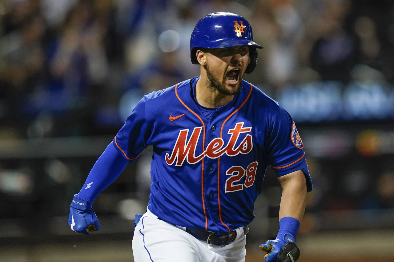 New York Mets' J.D. Davis celebrates after hitting a grand slam during the fifth inning of the team...