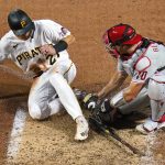 
              Pittsburgh Pirates' Kevin Newman (27) is tagged out by Philadelphia Phillies catcher J.T. Realmuto while attempting to score from third on a fielder's choice hit into by Ke'Bryan Hayes during the sixth inning of a baseball game in Pittsburgh, Saturday, July 30, 2022. (AP Photo/Gene J. Puskar)
            