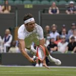 
              Taylor Fritz of the US dives to make a return to Australia's Jason Kubler in a men's singles fourth round match on day eight of the Wimbledon tennis championships in London, Monday, July 4, 2022. (AP Photo/Alastair Grant)
            