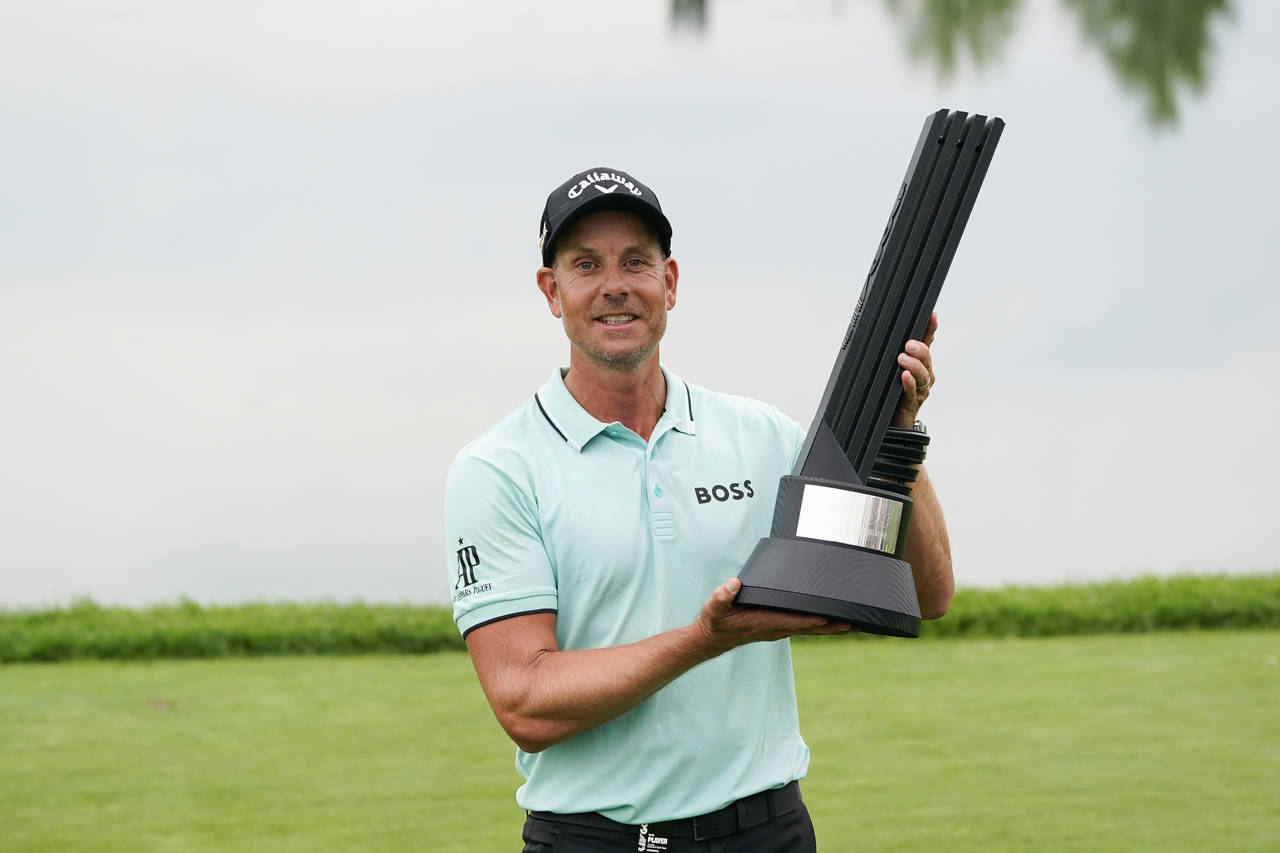 Henrik Stenson, of Sweden, holds the trophy after winning the LIV Golf Invitational at Trump Nation...