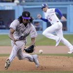 
              Colorado Rockies starting pitcher Jose Urena, left, fields a ball hit by Los Angeles Dodgers' Justin Turner as Freddie Freeman, right, runs to second during the first inning of a baseball game Wednesday, July 6, 2022, in Los Angeles. Turner was thrown out at first on the play. (AP Photo/Mark J. Terrill)
            