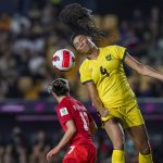 
              Jamaica's Chantelle Swaby (4) clears the ball next Canada's Jessie Fleming during a CONCACAF Women's Championship soccer semifinal match in Monterrey, Mexico, Thursday, July 14, 2022. (AP Photo/Fernando Llano)
            
