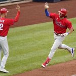 
              Philadelphia Phillies' Alec Bohm, right, rounds third to greetings from third base coach Dusty Wathan after hitting a solo home run off Pittsburgh Pirates relief pitcher Dillon Peters during the sixth inning of a baseball game in Pittsburgh, Sunday, July 31, 2022. (AP Photo/Gene J. Puskar)
            