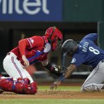 
              Texas Rangers catcher Jonah Heim tags out Seattle Mariners' Justin Upton (8) during the fourth inning of a baseball game Friday, July 15, 2022, in Arlington, Texas. (AP Photo/Tony Gutierrez)
            