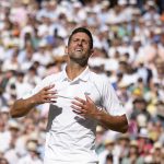 
              Serbia's Novak Djokovic celebrates after beating Australia's Nick Kyrgios to win the final of the men's singles on day fourteen of the Wimbledon tennis championships in London, Sunday, July 10, 2022. (AP Photo/Kirsty Wigglesworth)
            