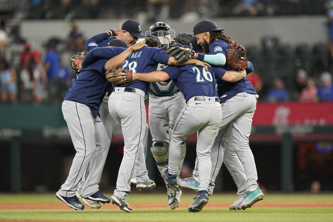 The Seattle Mariners dance in a circle after the final out of the baseball game against the Texas R...
