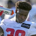 
              Houston Texans' Jacobi Francis sprays water on the back of his neck during an NFL football training camp practice Friday, July 29, 2022, in Houston. (AP Photo/David J. Phillip)
            