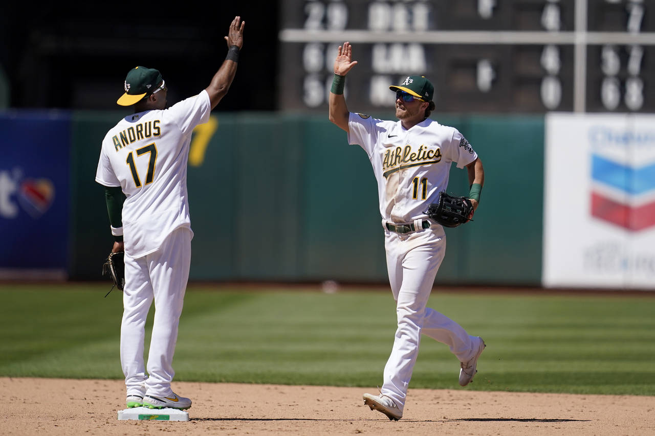Oakland Athletics' Elvis Andrus, left, celebrates with Skye Bolt after the Athletics defeated the H...