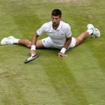 
              Serbia's Novak Djokovic reacts after making a passing shot to Italy's Jannik Sinner in a men's singles quarterfinal match on day nine of the Wimbledon tennis championships in London, Tuesday, July 5, 2022. (AP Photo/Alberto Pezzali)
            