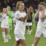 
              England's Leah Williamson, centre, and Ellen White celebrate as they won the Women Euro 2022 semi final soccer match between England and Sweden at the Bramall Lane Stadium in Sheffield, England, Tuesday, July 26, 2022. (AP Photo/Rui Vieira)
            