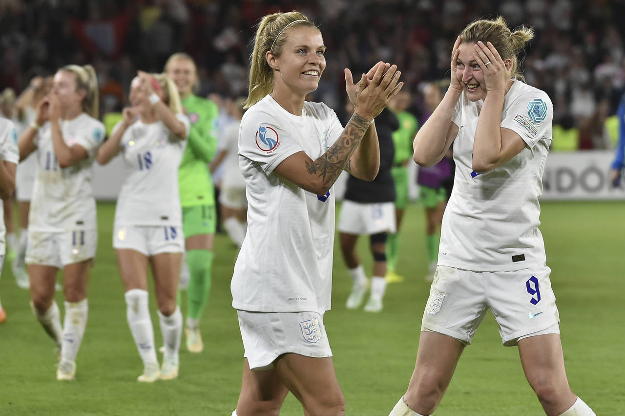 England's Leah Williamson, centre, and Ellen White celebrate as they won the Women Euro 2022 semi f...