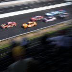 
              Christopher Bell (20) leads the field on a restart for the final segment during the running of a NASCAR Cup Series auto race at Indianapolis Motor Speedway, Sunday, July 31, 2022, in Indianapolis. (AP Photo/AJ Mast)
            