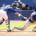 
              Tampa Bay Rays batter Randy Arozarena, right, is tagged out by Toronto Blue Jays catcher Gabriel Moreno after a dropped third strike in the first inning of a baseball game in Toronto, Sunday, July 3, 2022. (Jon Blacker/The Canadian Press via AP)
            