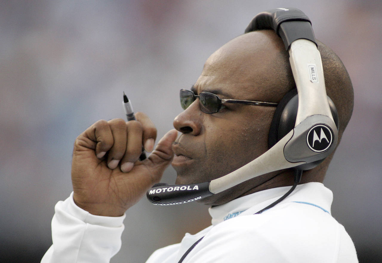 FILE - Carolina Panthers linebackers coach Sam Mills watches from the sideline during the team's NF...