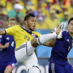 
              FILE - Colombia's Carlos Valdes, left, fights for the ball with Japan's Shinji Okazaki, during the group C World Cup soccer match between Japan and Colombia at the Arena Pantanal in Cuiaba, Brazil, June 24, 2014. Valdes will join Colombian soccer lover David Certain, who went to the U.S. as a political refugee, to teach at Certain's youth sports education program in New Mexico in July 2022. (AP Photo/Felipe Dana, File)
            