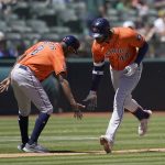 
              Houston Astros' Yordan Alvarez, right, is congratulated by third base coach Gary Pettis after hitting a home run against the Oakland Athletics during the sixth inning of a baseball game in Oakland, Calif., Wednesday, July 27, 2022. (AP Photo/Jeff Chiu)
            
