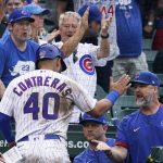 
              Chicago Cubs' Willson Contreras (40) is congratulated by manager David Ross, right, after scoring on a one-run single by Nico Hoerner during the eighth inning of a baseball game against the New York Mets in Chicago, Sunday, July 17, 2022. The Cubs won 3-2. (AP Photo/Nam Y. Huh)
            