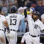 
              Detroit Tigers' Eric Haase, center, is greeted by Harold Castro, right, after the two-run home run that also scored Miguel Cabrera during the fourth inning of a baseball game against the Cleveland Guardians, Tuesday, July 5, 2022, in Detroit. (AP Photo/Carlos Osorio)
            