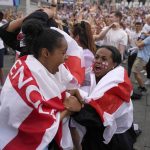 
              England supporters celebrate after Ella Toone scored the opening goal as they gather in the fan zone in Trafalgar Square to watch on a big screen the final of the Women's Euro 2022 soccer match between England and Germany being played at Wembley stadium in London, Sunday, July 31, 2022. (AP Photo/Frank Augstein)
            