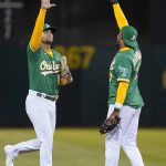 
              Oakland Athletics' Chad Pinder, left, celebrates with Elvis Andrus after the Athletics defeated the Texas Rangers in a baseball game in Oakland, Calif., Saturday, July 23, 2022. (AP Photo/Jeff Chiu)
            