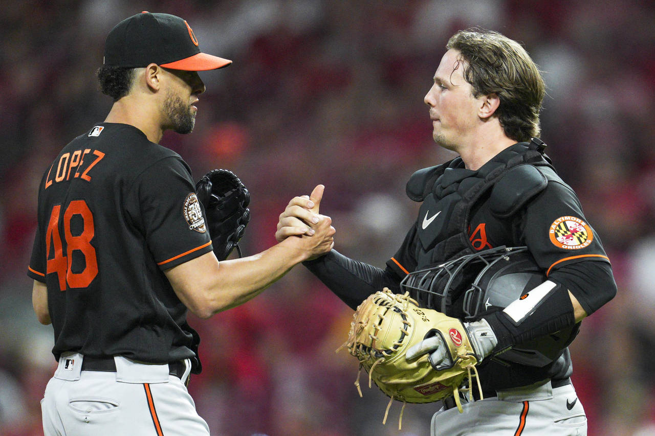 Baltimore Orioles relief pitcher Jorge Lopez (48) celebrates with catcher Adley Rutschman after the...