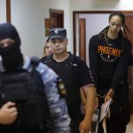 
              WNBA star and two-time Olympic gold medalist Brittney Griner is escorted to a courtroom for a hearing, in Khimki just outside Moscow, Russia, Wednesday, July 27, 2022. American basketball star Brittney Griner returned Wednesday to a Russian courtroom for her drawn-out trial on drug charges that could bring her 10 years in prison of convicted. (Evgenia Novozhenina/Pool Photo via AP)
            