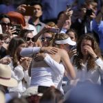 
              Kazakhstan's Elena Rybakina is embraced by family, friends and coaches in the players box as she celebrates after beating Tunisia's Ons Jabeur to win the final of the women's singles on day thirteen of the Wimbledon tennis championships in London, Saturday, July 9, 2022. (AP Photo/Kirsty Wigglesworth)
            