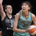 
              FILE - New York Liberty center Han Xu (21) drives against Seattle Storm forward Breanna Stewart, left, during the second half of a WNBA basketball game, Sunday, June 19, 2022, in New York. Standing 6-10, Han would like to emulate Yao Ming's impact — including his influence on the sport in China. She wants to be a female beacon of basketball in her native land. (AP Photo/Mary Altaffer, File)
            