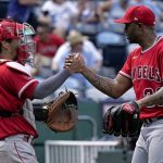 
              Los Angeles Angels catcher Kurt Suzuki and relief pitcher Raisel Iglesias celebrate after their baseball game game against the Kansas City Royals Wednesday, July 27, 2022, in Kansas City, Mo. The Angels won 4-0. (AP Photo/Charlie Riedel)
            