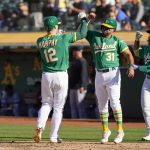 
              Oakland Athletics' Sean Murphy (12) celebrates with Vimael Machin (31) and Ramon Laureano (22) after hitting a three-run home run against the Detroit Tigers during the sixth inning of the second baseball game of a doubleheader in Oakland, Calif., Thursday, July 21, 2022. (AP Photo/Godofredo A. Vásquez)
            