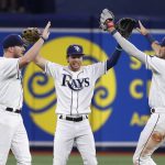 
              Tampa Bay Rays' Brett Phillips, center, celebrates with Luke Raley, left, and Josh Lowe after the Rays defeated the Boston Red Sox in a baseball game Thursday, July 14, 2022, in St. Petersburg, Fla. (AP Photo/Scott Audette)
            
