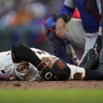 
              San Francisco Giants' Thairo Estrada remains on the ground after being hit by a pitch during the fifth inning of the team's baseball game against the Chicago Cubs in San Francisco, Saturday, July 30, 2022. (AP Photo/Godofredo A. Vásquez)
            