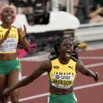 
              Jamaica's Shericka Jackson celebrates after running the 200 meters in the second-fastest time ever, 21.45 seconds, to lead a Jamaican 1-2 finish ahead of Shelly-Ann Fraser-Pryce, at the World Athletics Championships, in Eugene, Ore., Thursday, July 21, 2022. (AP Photo/Gregory Bull)
            
