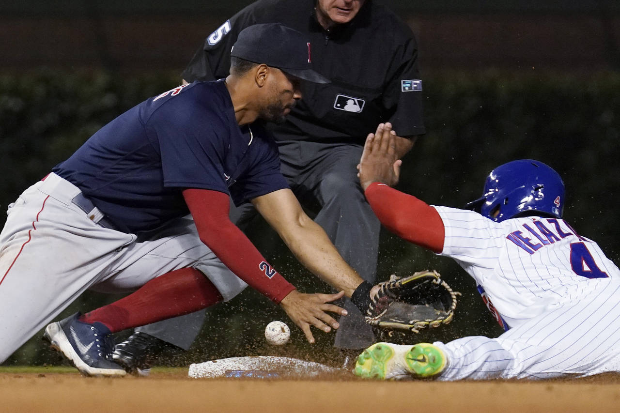 Chicago Cubs' Nelson Velazquez, right, asks for time after second base, next to Boston Red Sox shor...