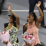 
              FILE - Venus Williams, left, celebrates winning against her sister Serena, right, after a match on the opening day of the Mubadala World Tennis Championship in Abu Dhabi, United Arab Emirates, Dec. 27, 2018. Seven-time Grand Slam champion Venus Williams has been given a wild-card entry into the main draw of the National Bank Open next month. Her sister Serena Williams also is playing in Toronto. (AP Photo/Kamran Jebreili, File)
            