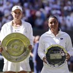 
              Kazakhstan's Elena Rybakina, left, holds the trophy after beating Tunisia's Ons Jabeur to win the final of the women’s singles on day thirteen of the Wimbledon tennis championships in London, Saturday, July 9, 2022. (Zac Goodwin/PA via AP)
            