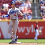 
              Los Angeles Dodgers' Trea Turner gestures at second base after hitting an RBI-double during the sixth inning a baseball game against the Cincinnati Reds in Cincinnati, Thursday, June 23, 2022. The Dodgers won 10-5. (AP Photo/Aaron Doster)
            