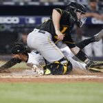 
              Miami Marlins' Billy Hamilton, rear, scores against Pittsburgh Pirates catcher Jason Delay during the fifth inning of a baseball game, Thursday, July 14, 2022, in Miami. (AP Photo/Wilfredo Lee)
            