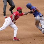 
              Texas Rangers' Marcus Semien, right, is tagged out by Los Angeles Angels second baseman Luis Rengifo after being caught between first and second while trying to steal second during the third inning of a baseball game Sunday, July 31, 2022, in Anaheim, Calif. (AP Photo/Mark J. Terrill)
            