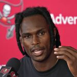 
              New Tampa Bay Buccaneers wide receiver Julio Jones answers a question during a news conference after arriving at an NFL football training camp practice Wednesday, July 27, 2022, in Tampa, Fla. (AP Photo/Chris O'Meara)
            