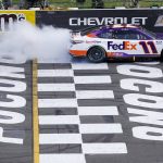 
              Denny Hamlin (11) smokes his tires at the finish line in celebration after winning the NASCAR Cup Series auto race at Pocono Raceway, Sunday, July 24, 2022, in Long Pond, Pa. (AP Photo/Matt Slocum)
            